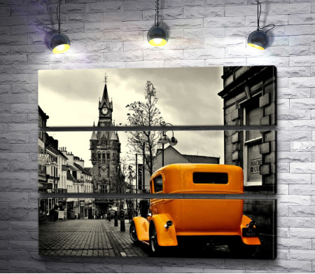 Оранжевый автомобиль в черно белом городе
