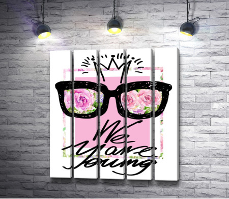 Плакат с надписью "We are young" на розовом фоне и розами в очках