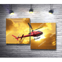 Красный вертолет в облаках на закате 