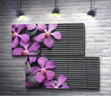 Лиловые орхидеи на камнях и бамбуковом коврике