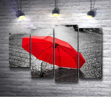 Красный зонт лежит на асфальте 
